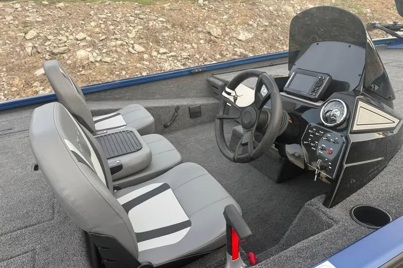 Slide: The Image of 2026 Lowe Stinger 195 Bass boat interior with steering console and dual seats. - 8