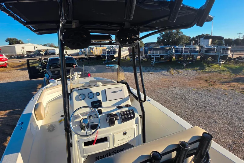 Slide: The Image of 2017 NauticStar 231 Angler boat interior with steering console and navigation equipment. - 11