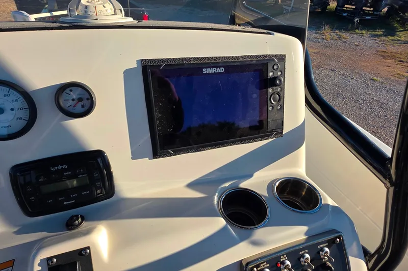 Slide: The Image of 2017 NauticStar 231 Angler dashboard with Simrad display and gauges. - 13