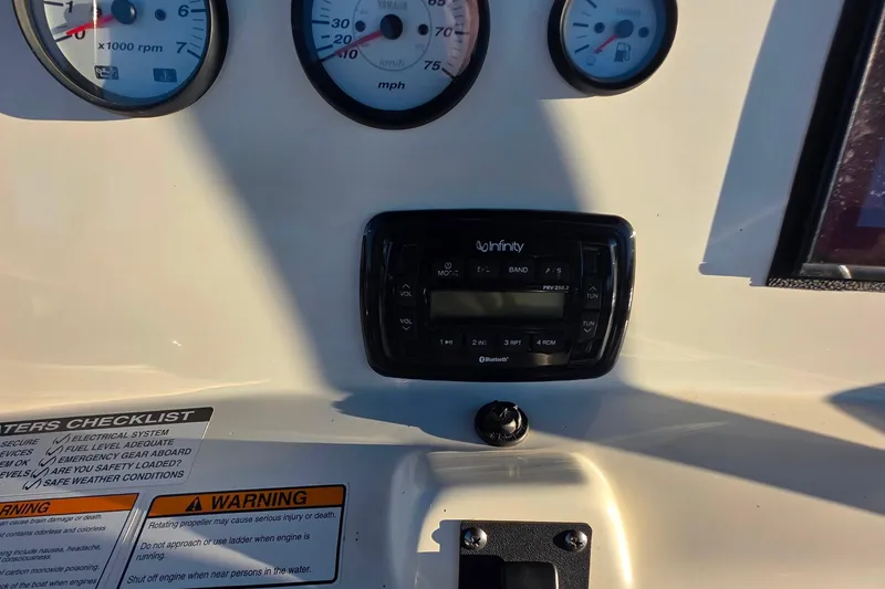 Slide: The Image of Dashboard of 2017 NauticStar 231 Angler with gauges and Infinity stereo system. - 14