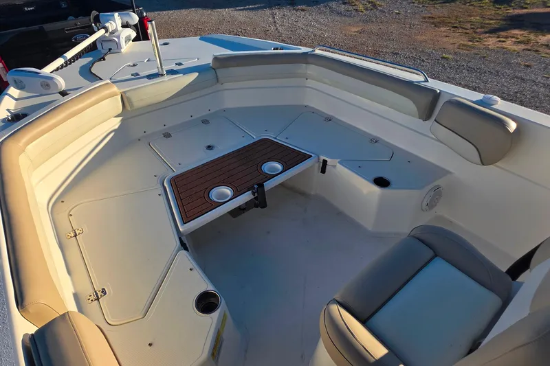 Slide: The Image of 2017 NauticStar 231 Angler boat interior with seating and table setup. - 16