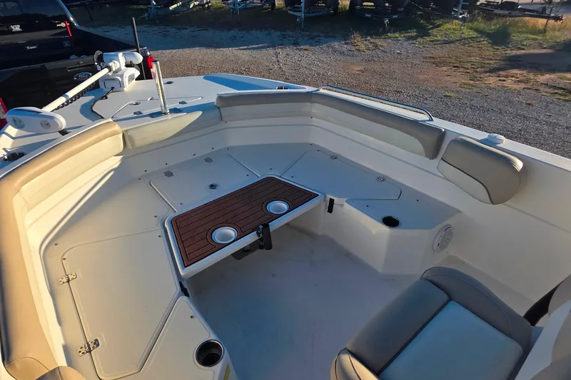 Slide: The Image of 2017 NauticStar 231 Angler boat interior with seating and table, ideal for fishing trips. - 17