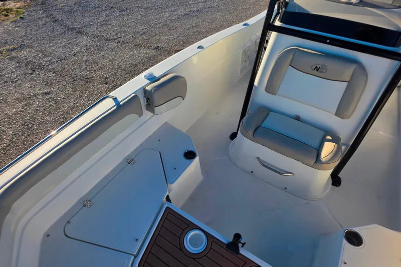 Slide: The Image of 2017 NauticStar 231 Angler boat interior with seating and storage compartments. - 20