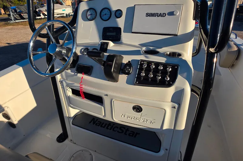 Slide: The Image of 2017 NauticStar 231 Angler boat console with steering wheel and Simrad electronics. - 22