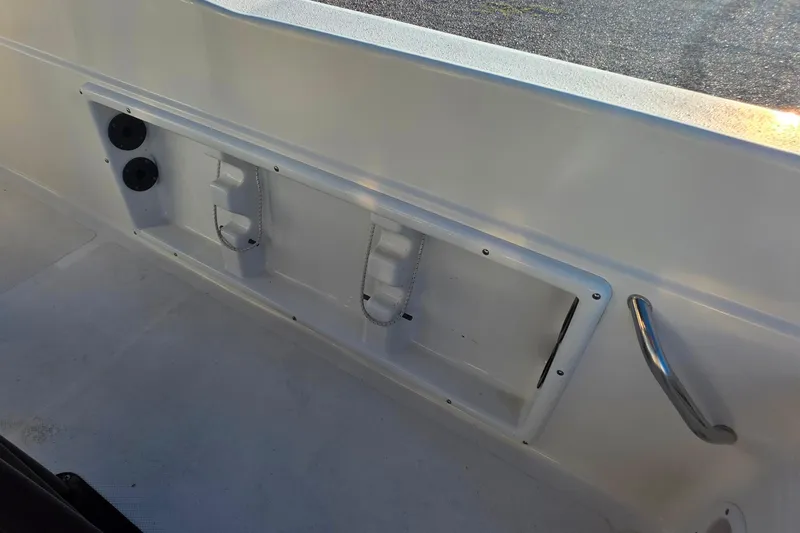 Slide: The Image of 2017 NauticStar 231 Angler boat interior with storage compartments and handle. - 23