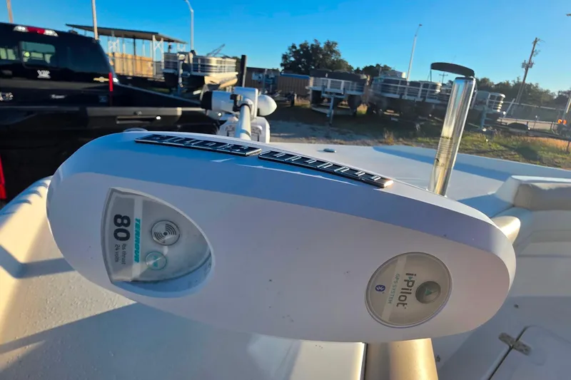 Slide: The Image of 2017 NauticStar 231 Angler with Minn Kota i-Pilot trolling motor in a parking lot. - 24