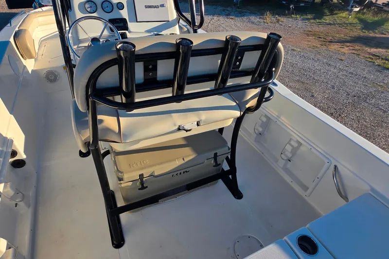Slide: The Image of 2017 NauticStar 231 Angler boat interior with helm, seating, and rod holders. - 28