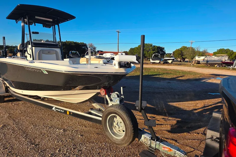 Slide: The Image of 2017 NauticStar 231 Angler boat on trailer in outdoor setting. - 29