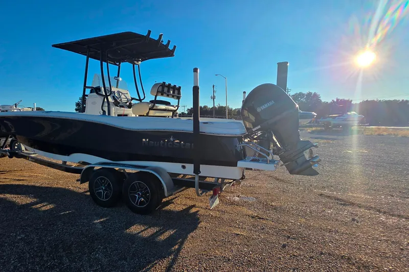 Slide: The Image of 2017 NauticStar 231 Angler boat on trailer, sunny day, Yamaha outboard motor. - 3