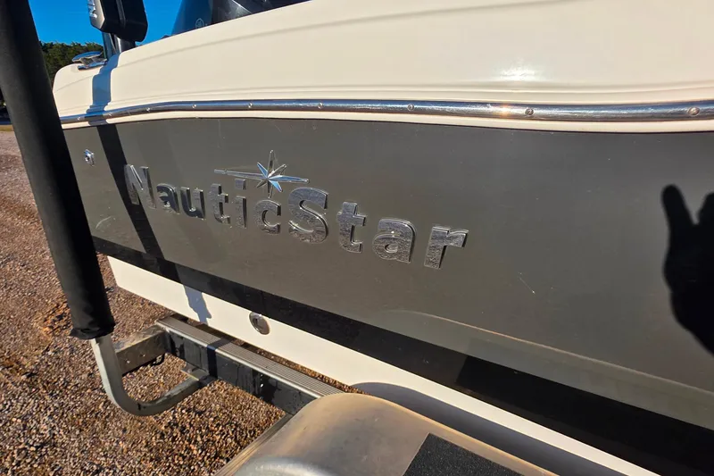 Slide: The Image of 2017 NauticStar 231 Angler boat logo on side panel in sunlight. - 4