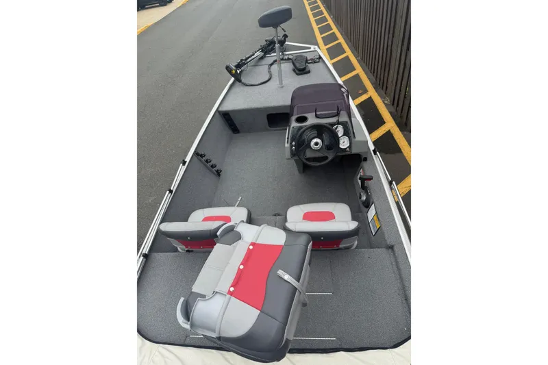 Slide: The Image of 2015 Tracker Pro 160 boat interior with steering console and seating. - 2