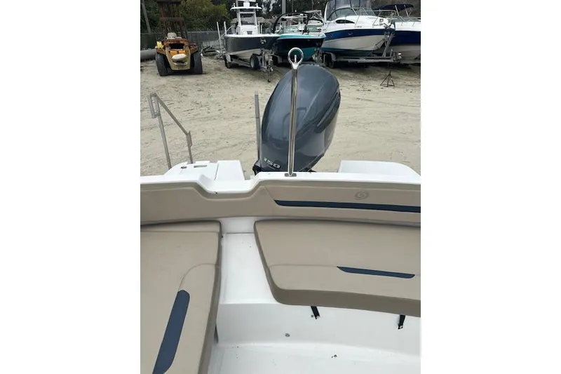 Slide: The Image of 2023 Hurricane SunDeck Sport 205 OB boat with outboard motor, docked on sandy shore. - 10