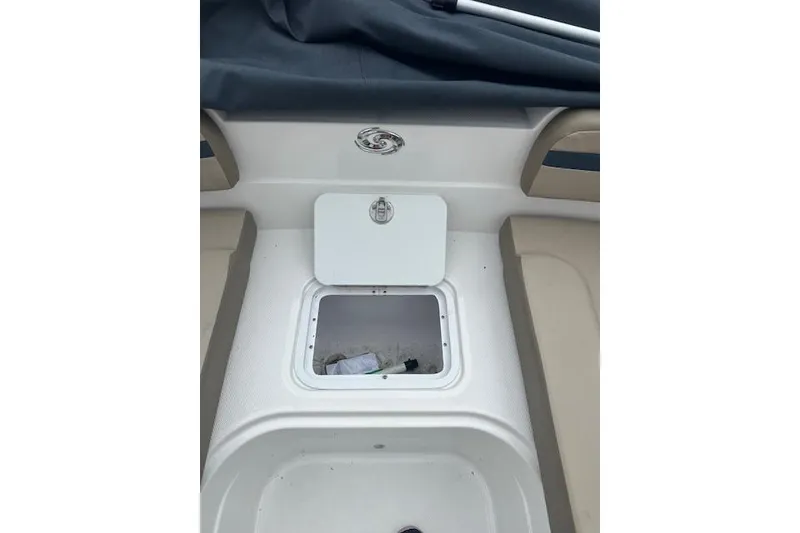 Slide: The Image of 2023 Hurricane SunDeck Sport 205 OB boat storage compartment with open hatch. - 13