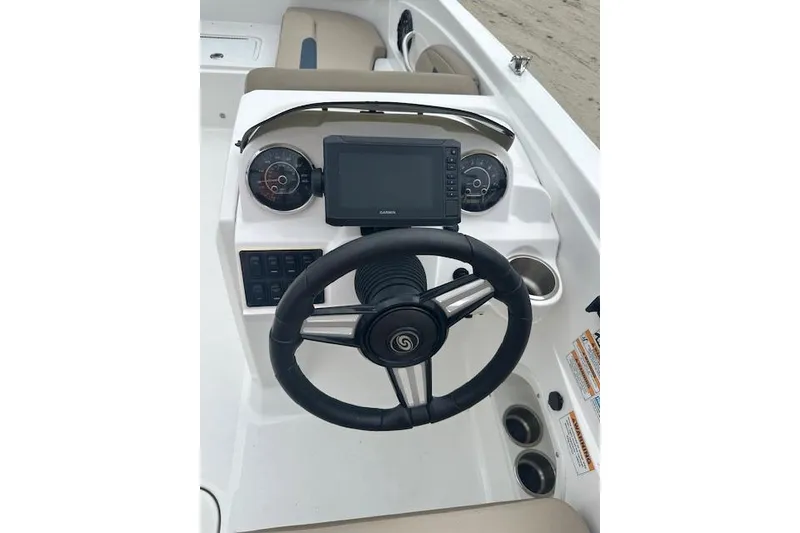 Slide: The Image of 2023 Hurricane SunDeck Sport 205 OB dashboard with steering wheel and navigation display. - 4