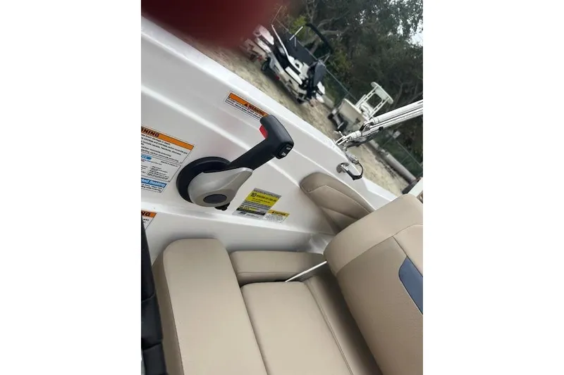 Slide: The Image of 2023 Hurricane SunDeck Sport 205 OB interior with throttle control and beige seating. - 7