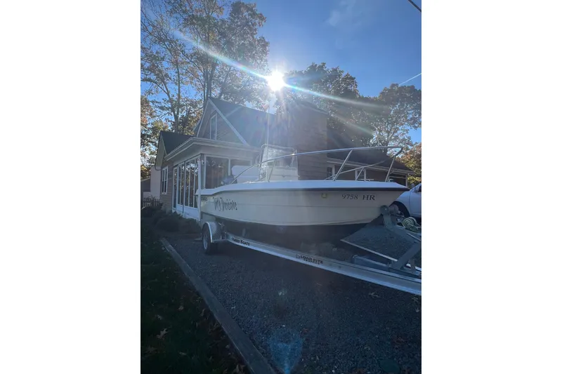 Slide: The Image of 1994 Stratos 1850 Center Console boat with Yamaha 150 engine on trailer. - 2