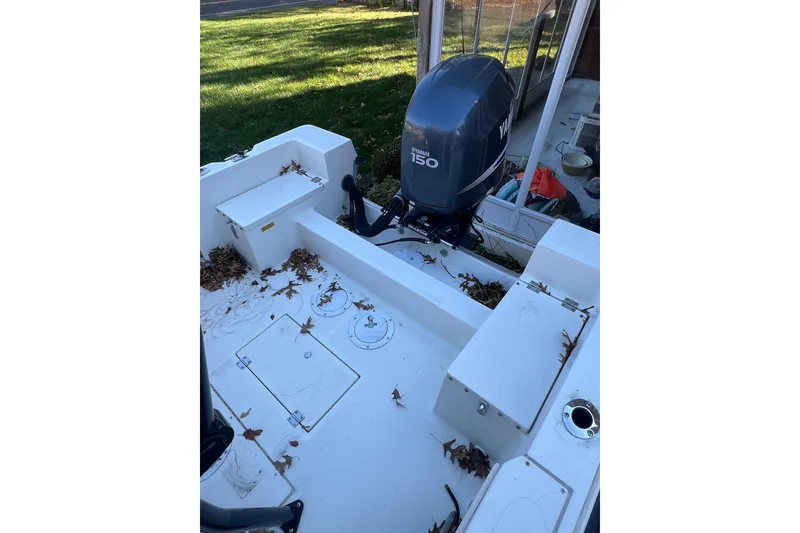 Slide: The Image of 1994 Stratos 1850 Center Console dashboard with Simrad and Yamaha displays. - 12