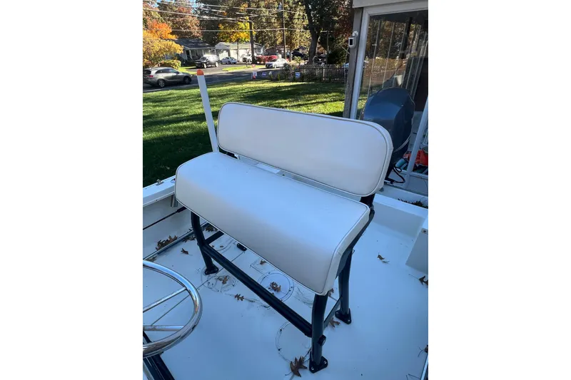 Slide: The Image of 1994 Stratos 1850 Center Console boat with white seating and outdoor background. - 10