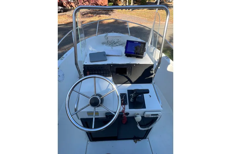 Slide: The Image of 1994 Stratos 1850 Center Console boat with steering wheel and navigation equipment. - 4