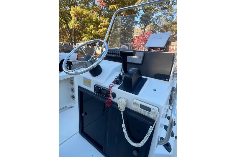 Slide: The Image of 1994 Stratos 1850 Center Console boat dashboard with steering wheel and controls. - 5