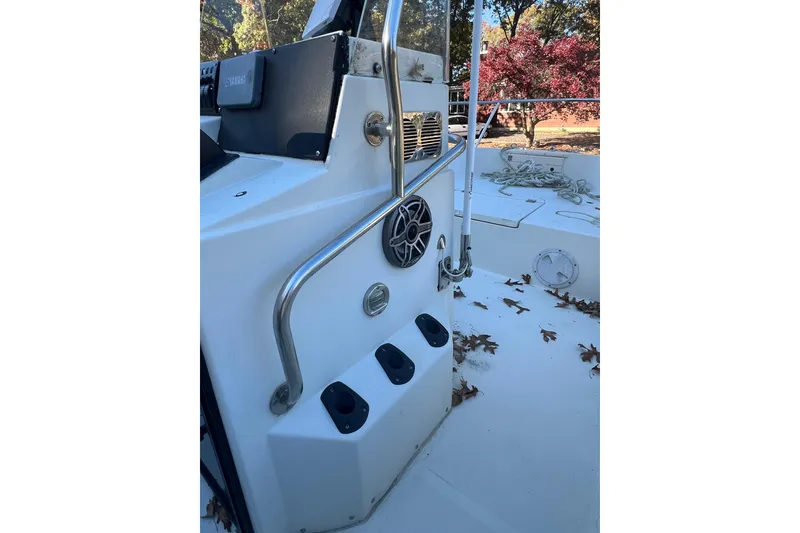 Slide: The Image of 1994 Stratos 1850 Center Console boat interior with steering console and metal railings. - 8