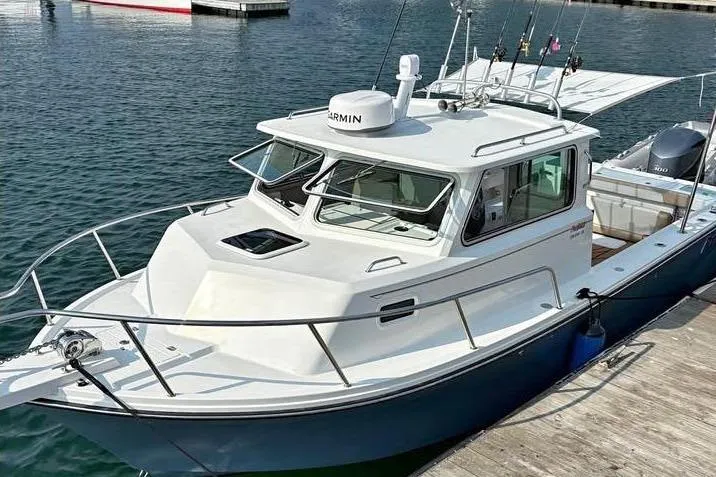 The Image of 2019 Parker 2520 XL Sport Cabin boat docked in calm waters. - 0
