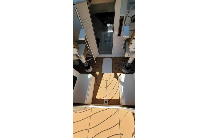 Slide: The Image of 2019 Parker 2520 XL Sport Cabin interior with teak flooring and modern controls. - 12