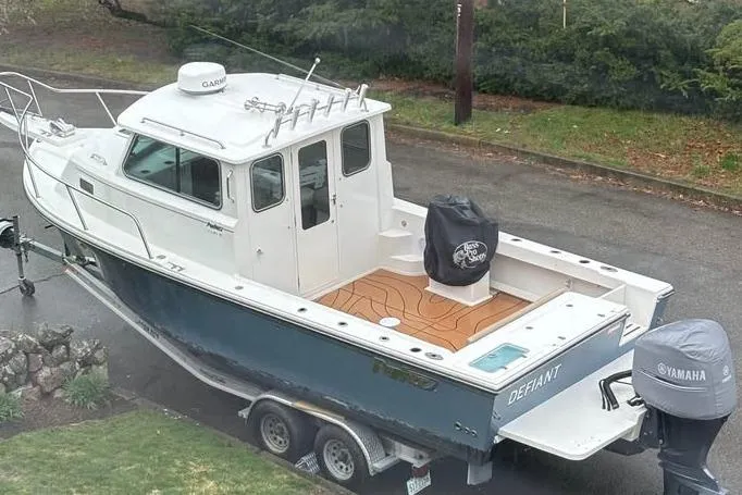 Slide: The Image of 2019 Parker 2520 XL Sport Cabin boat on trailer, featuring Yamaha engine and Garmin equipment. - 2