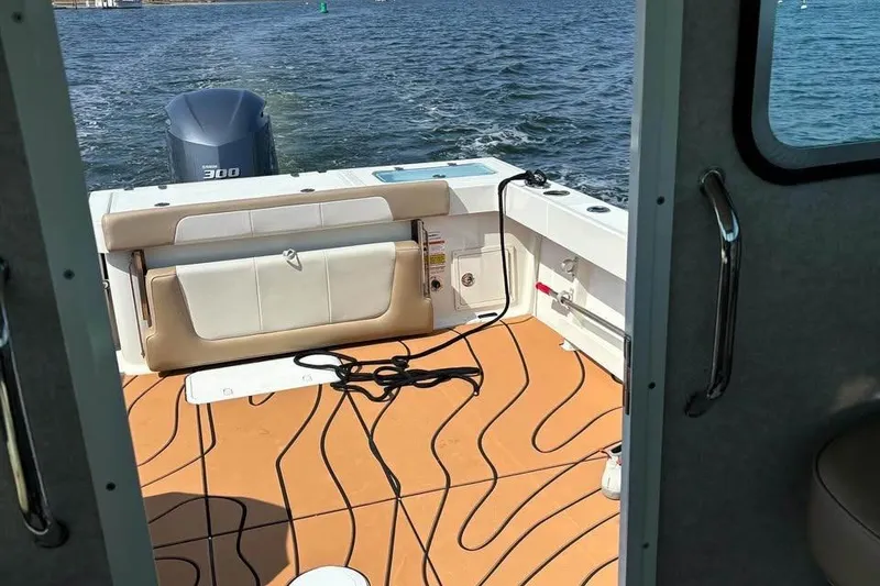 Slide: The Image of 2019 Parker 2520 XL Sport Cabin boat interior with Yamaha 300 engine on water. - 4