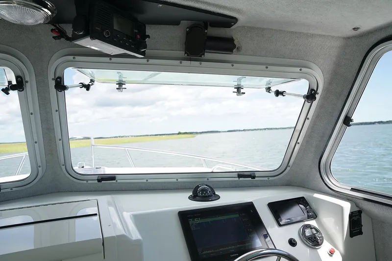 Slide: The Image of Manufacturer Provided Image: Interior view of 2019 Parker 2520 XL Sport Cabin boat with navigation equipment. - 6