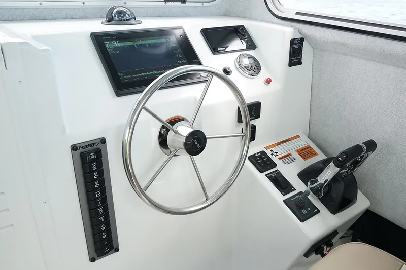Slide: The Image of Manufacturer Provided Image: 2019 Parker 2520 XL Sport Cabin helm with steering wheel and control panel. - 7