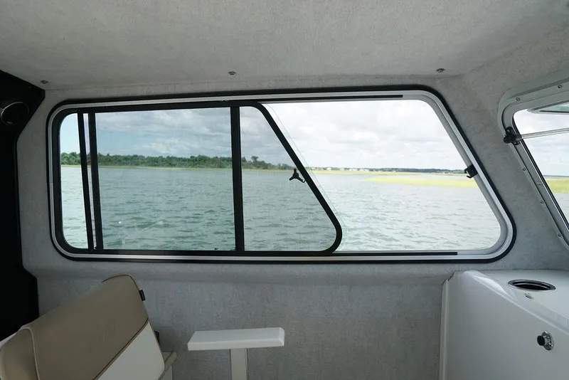 Slide: The Image of Manufacturer Provided Image: Interior view of 2019 Parker 2520 XL Sport Cabin boat with window overlooking water. - 8