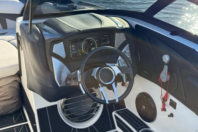 Slide: The Image of 2019 Centurion Fi25 boat dashboard with steering wheel and control panel. - 16
