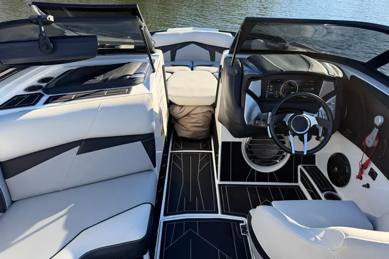 Slide: The Image of Interior of a 2019 Centurion Fi25 boat with modern dashboard and seating. - 17