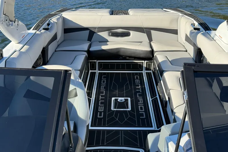 Slide: The Image of 2019 Centurion Fi25 boat interior with luxurious seating and branded flooring on the water. - 18