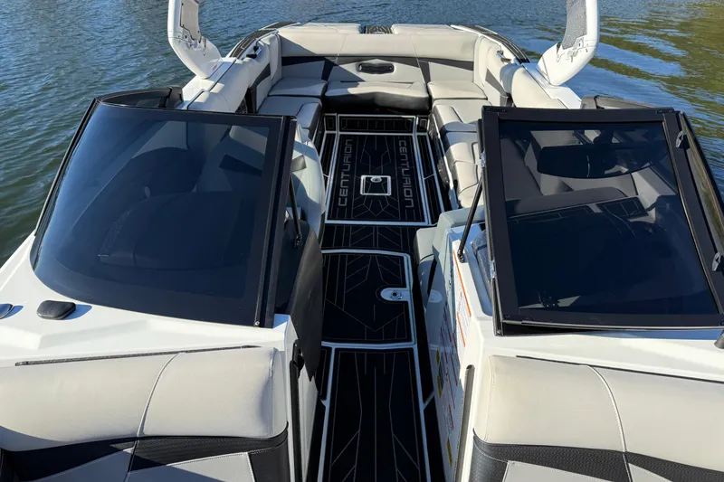 Slide: The Image of 2019 Centurion Fi25 boat interior with sleek seating and open deck on water. - 19