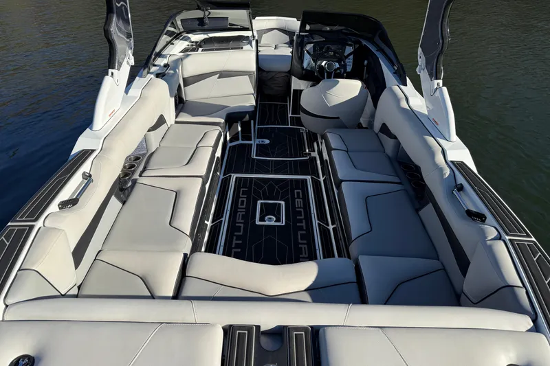 Slide: The Image of 2019 Centurion Fi25 boat interior with luxurious seating and sleek design on the water. - 22