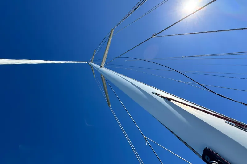 Slide: The Image of Looking up at the mast of a 2013 Tartan 4000 sailboat against a clear blue sky. - 36