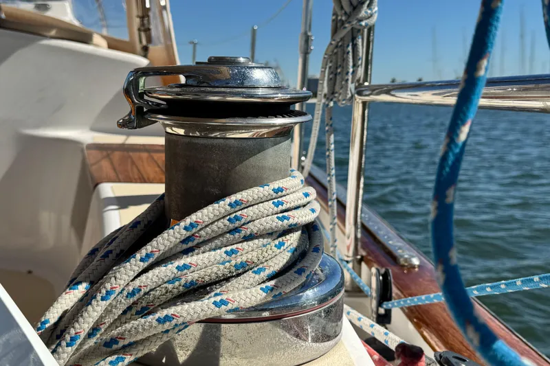 Slide: The Image of Winch on 2013 Tartan 4000 sailboat with ropes, docked by the water. - 45