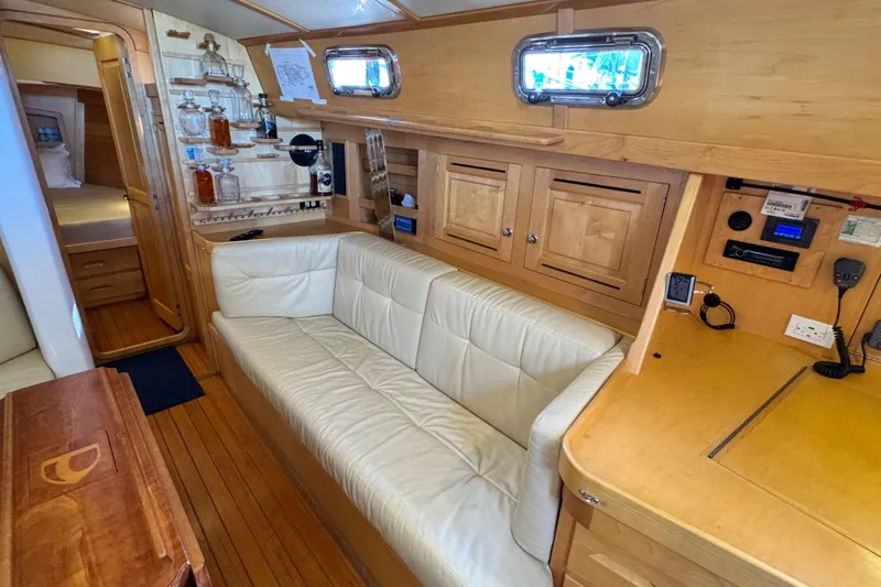 Slide: The Image of Luxurious 2013 Tartan 4000 yacht interior with white leather sofa and wooden cabinetry. - 53