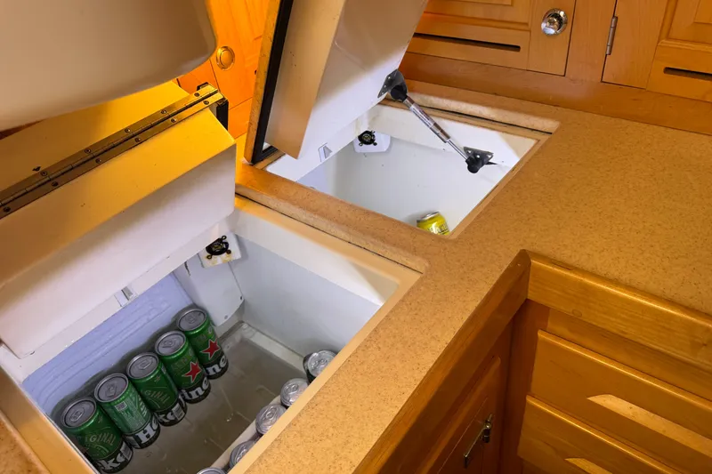 Slide: The Image of Built-in coolers with beverages in a 2013 Tartan 4000 yacht kitchen. - 59