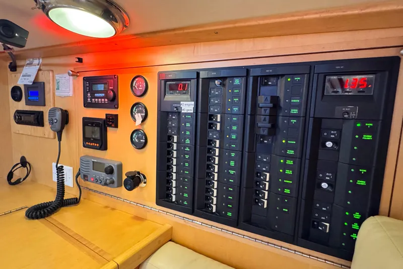 Slide: The Image of Control panel inside a 2013 Tartan 4000 yacht, featuring various switches and gauges. - 63