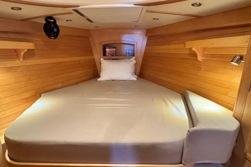 Slide: The Image of Cozy wooden cabin interior of 2013 Tartan 4000 sailboat with bed and shelves. - 64
