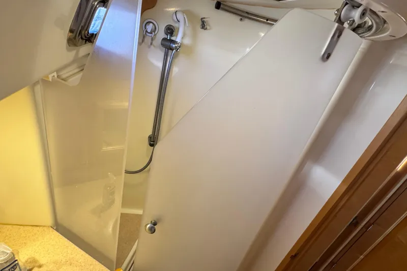 Slide: The Image of Shower area in 2013 Tartan 4000 yacht with modern fixtures and frosted door. - 68