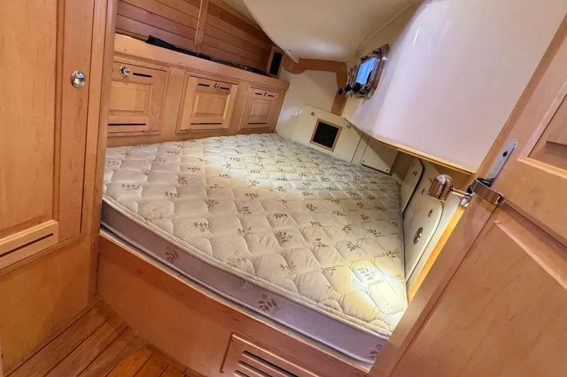 Slide: The Image of Cozy cabin interior of 2013 Tartan 4000 sailboat with wooden cabinetry and comfortable mattress. - 71