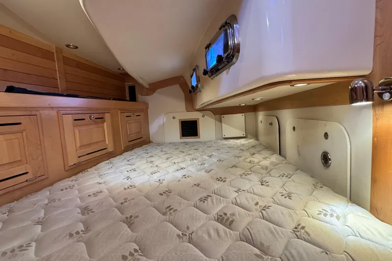 Slide: The Image of Cozy cabin interior of 2013 Tartan 4000 sailboat with wood cabinetry and porthole window. - 72