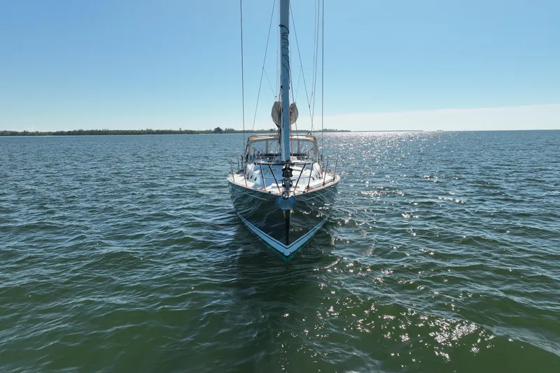 Slide: The Image of Sailboat Tartan 4000 (2013) on calm water under clear blue sky. - 8