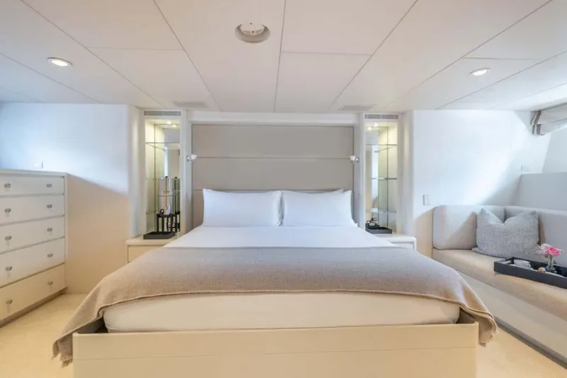 Slide: The Image of Luxurious bedroom interior on 1995 Christensen Tri-Deck yacht, featuring elegant decor and cozy seating. - 12