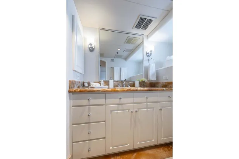 Slide: The Image of Luxurious bathroom vanity on 1995 Christensen Tri-Deck yacht, featuring elegant cabinetry and marble countertop. - 15