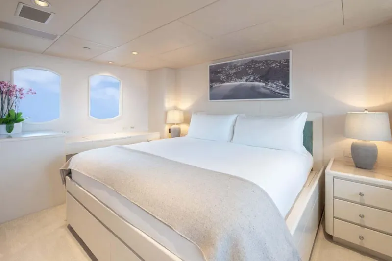 Slide: The Image of Luxurious bedroom on 1995 Christensen Tri-Deck yacht with elegant decor and ocean view. - 18